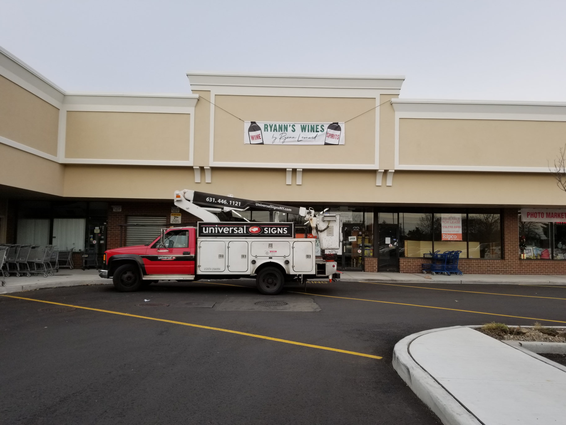 Ryann's Wines temporary storefront banner installed by Universal Signs